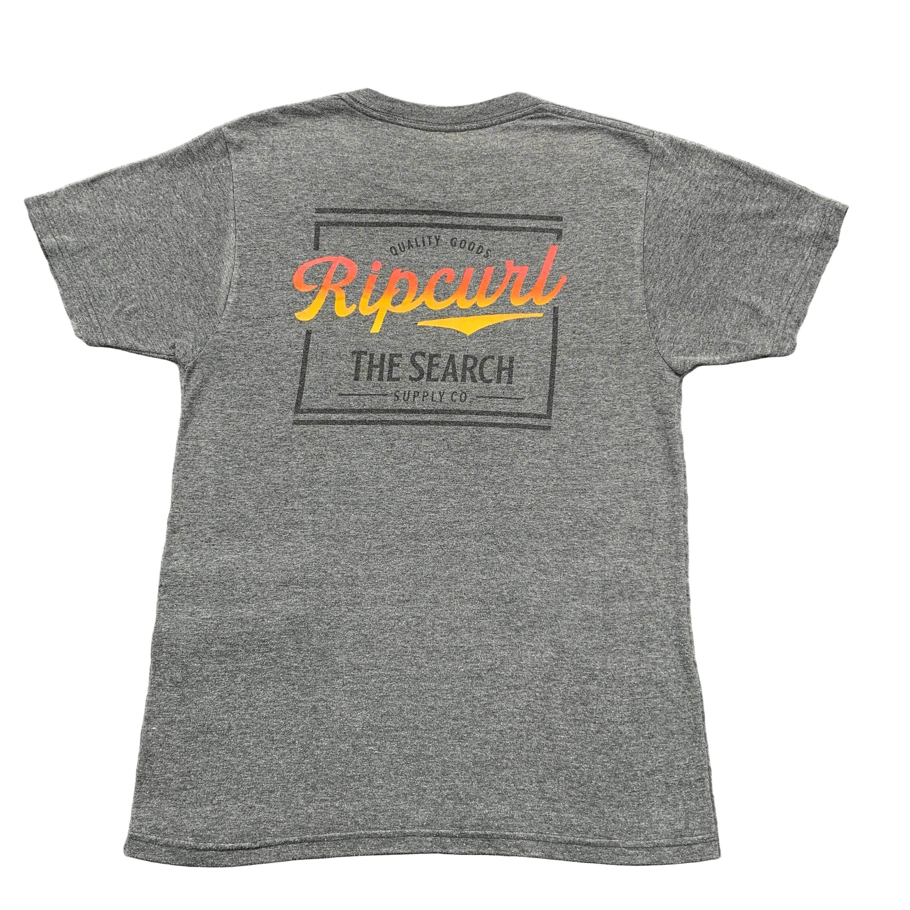 Gray t-shirt with Rip Curl logo on the back, laid flat on a textured surface.