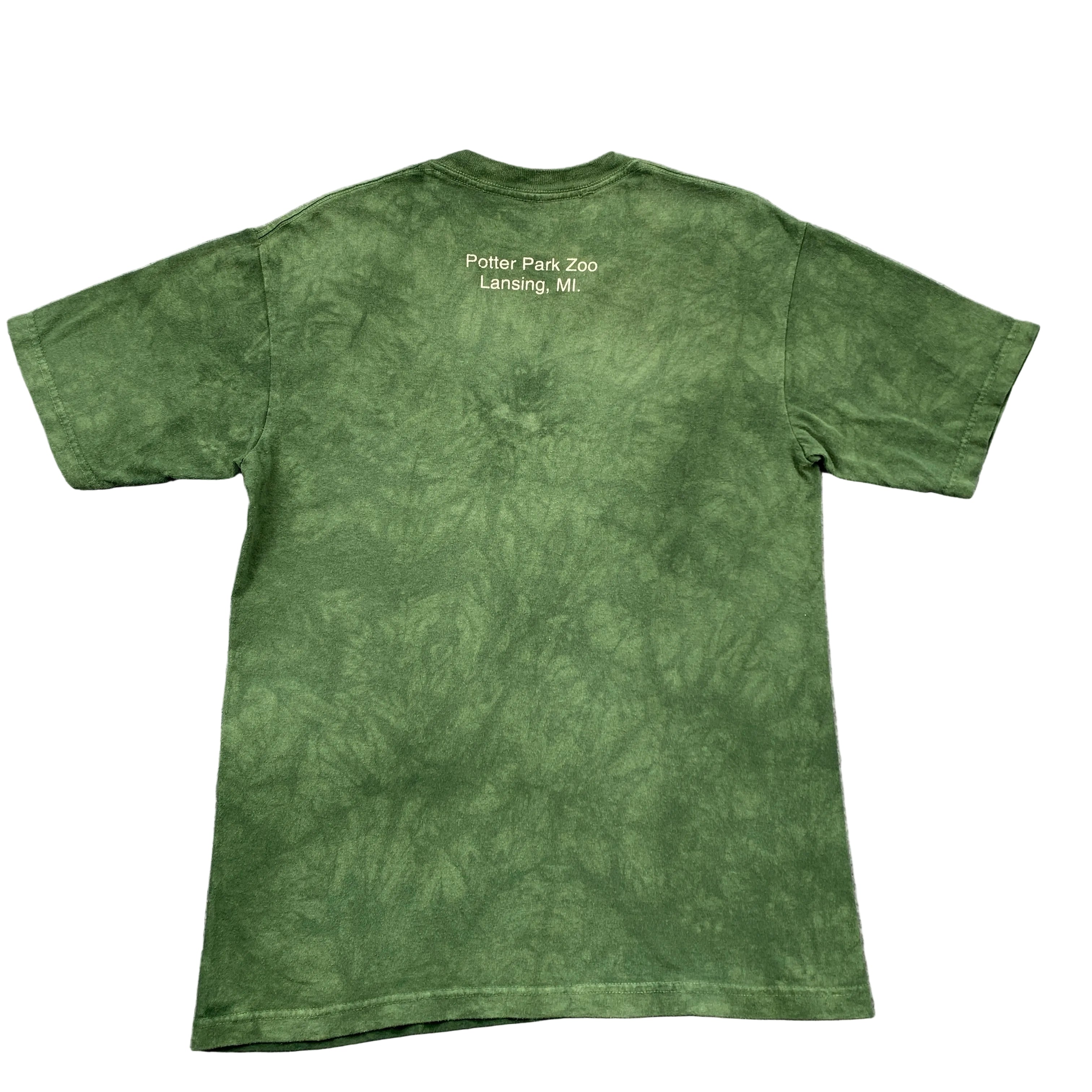 Green t-shirt with text on the back, laid flat on a gray surface
