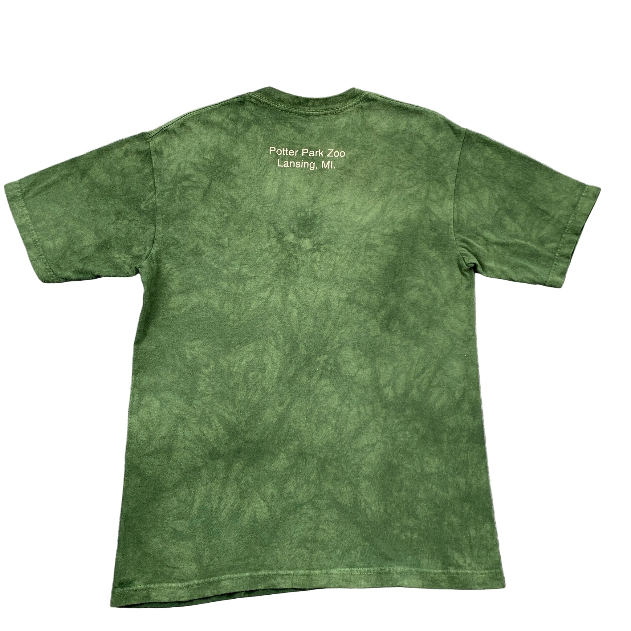 Green t-shirt with text on the back, laid flat on a gray surface