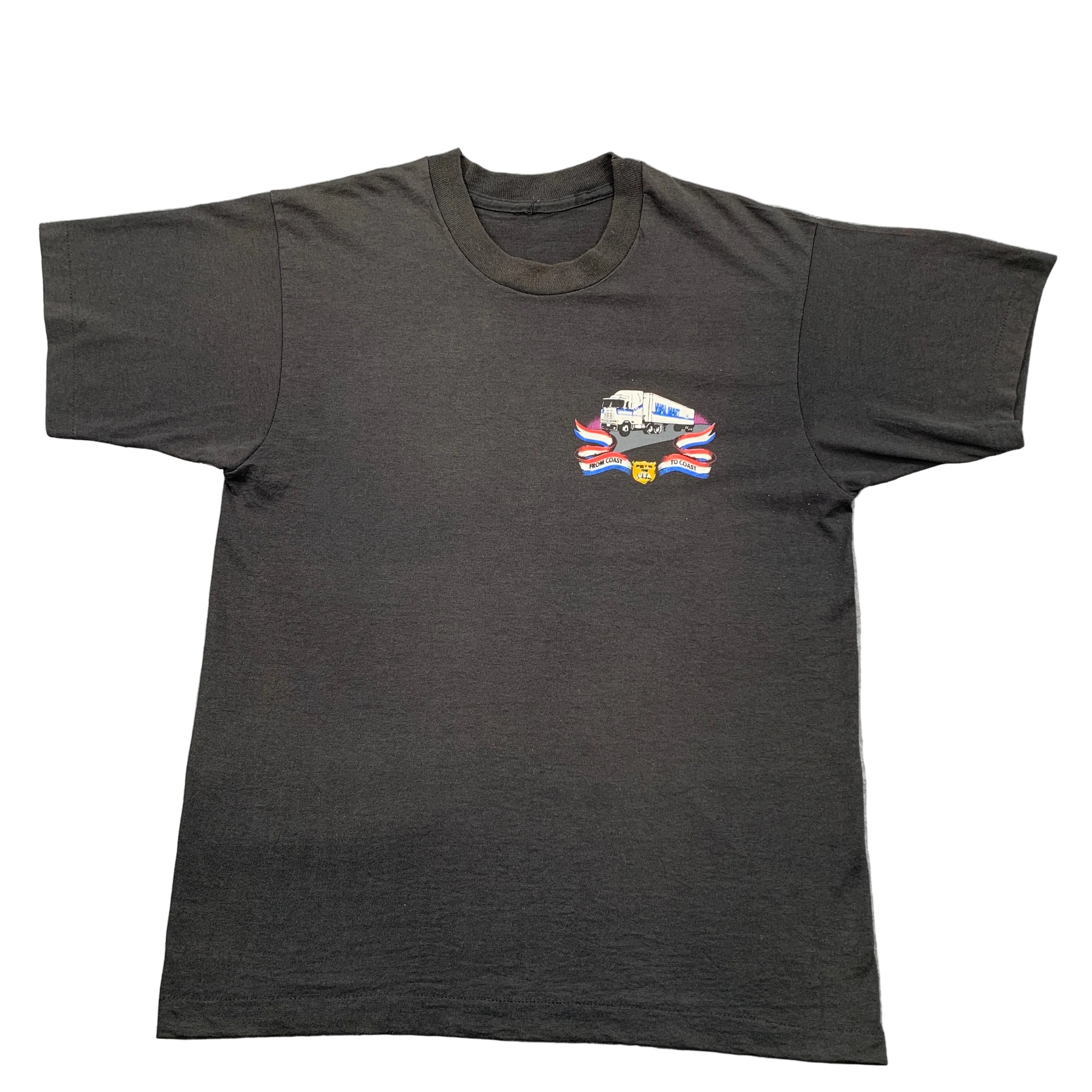 Black t-shirt with a graphic design on a gray surface
