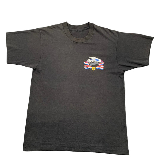Black t-shirt with a graphic design on a gray surface