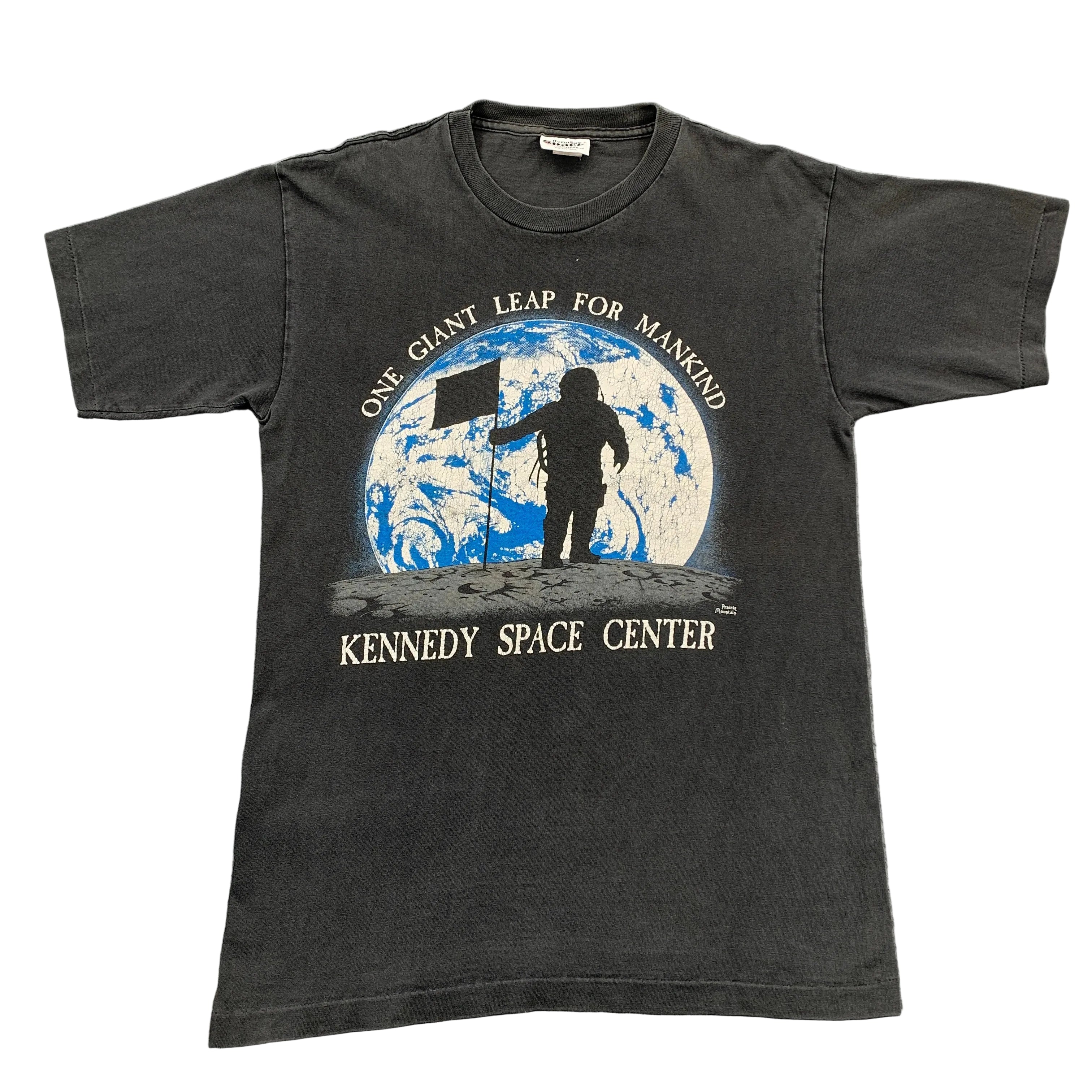 Black t-shirt with Kennedy Space Center graphic on a gray background