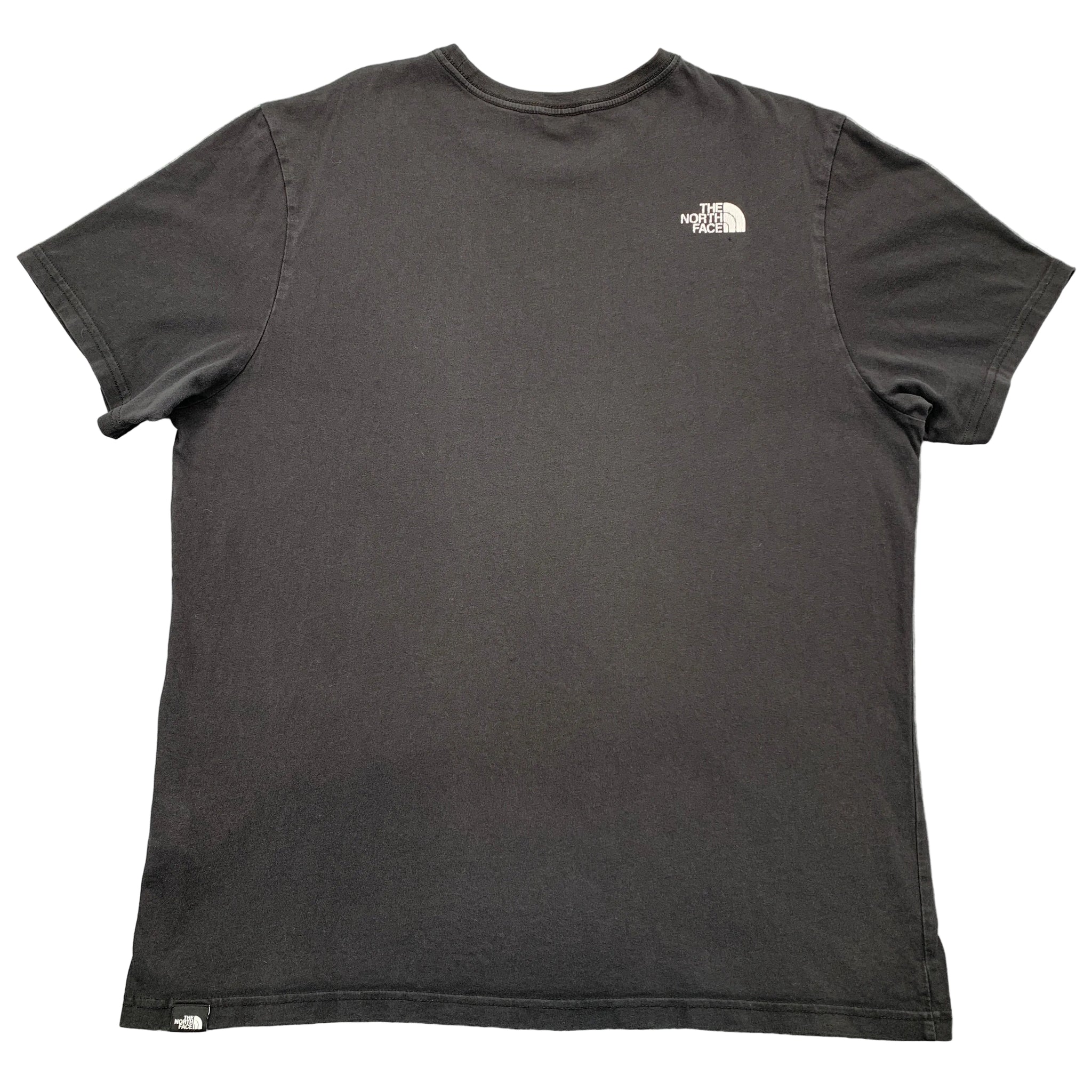 Black t-shirt with a logo on the chest against a gray background