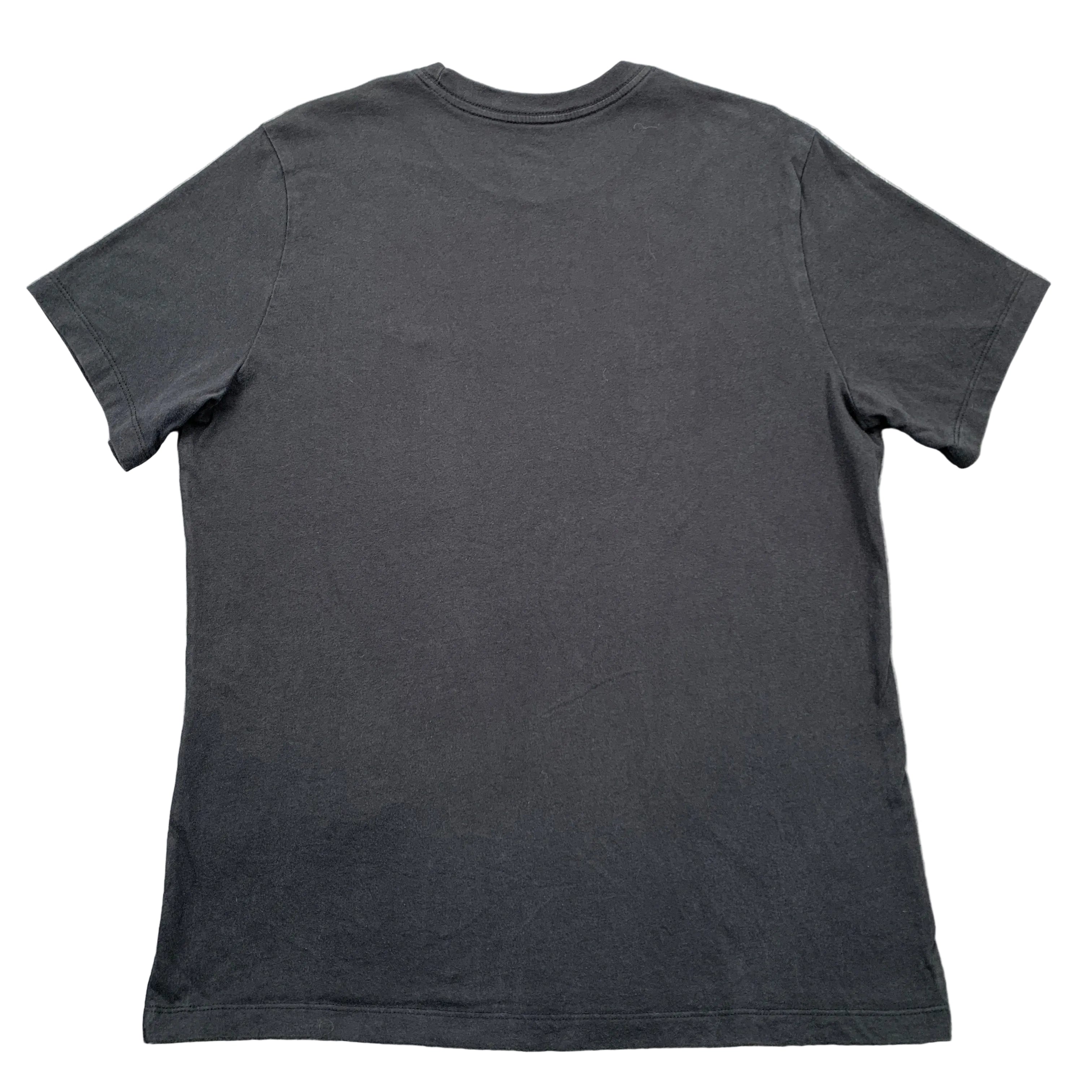 Black t-shirt on a gray concrete surface