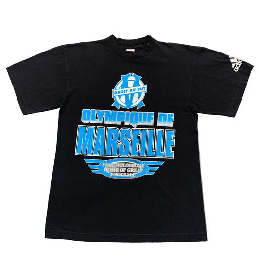 Black t-shirt with Olympique de Marseille logo on a gray surface