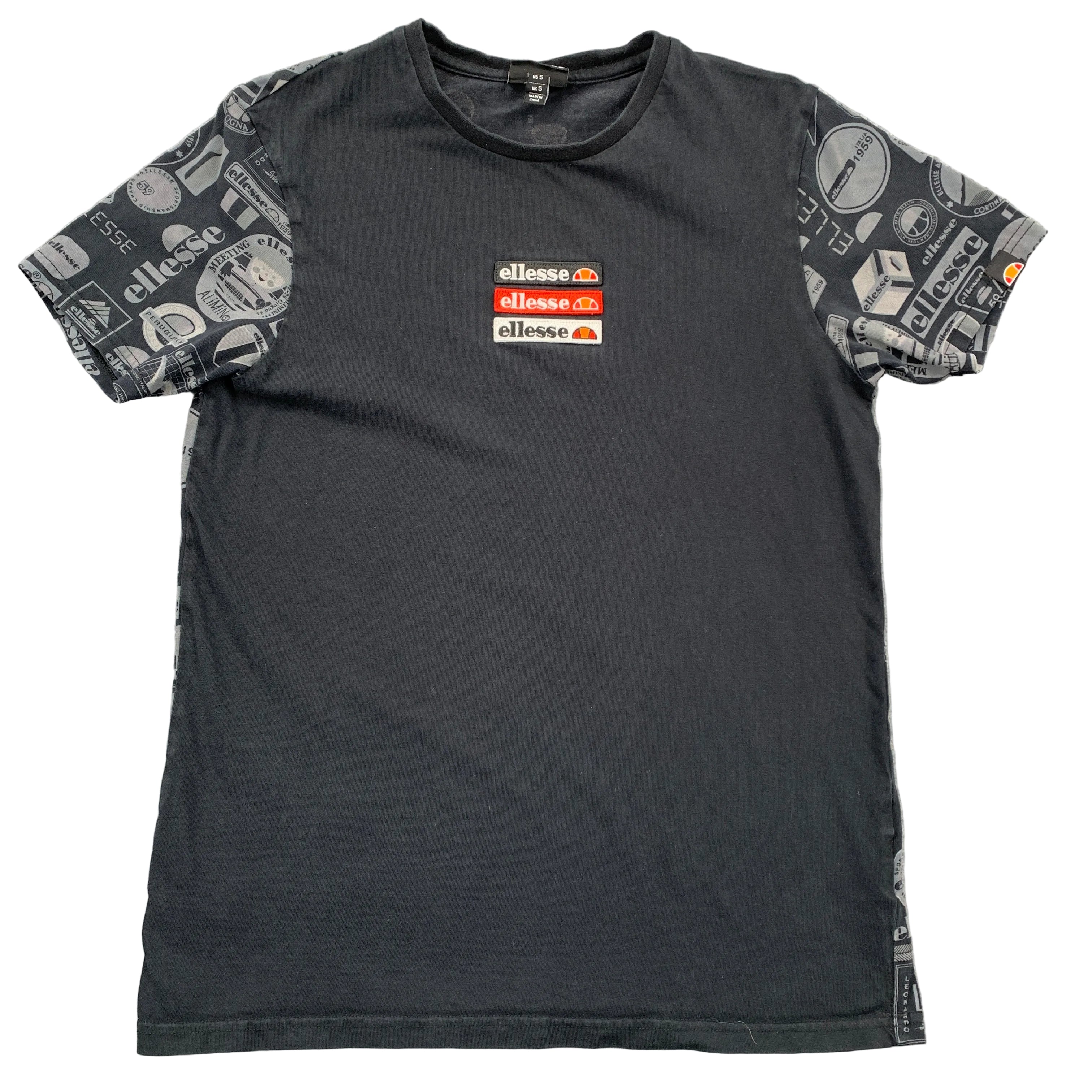Black t-shirt with patterned sleeves and Ellesse logo on a gray surface
