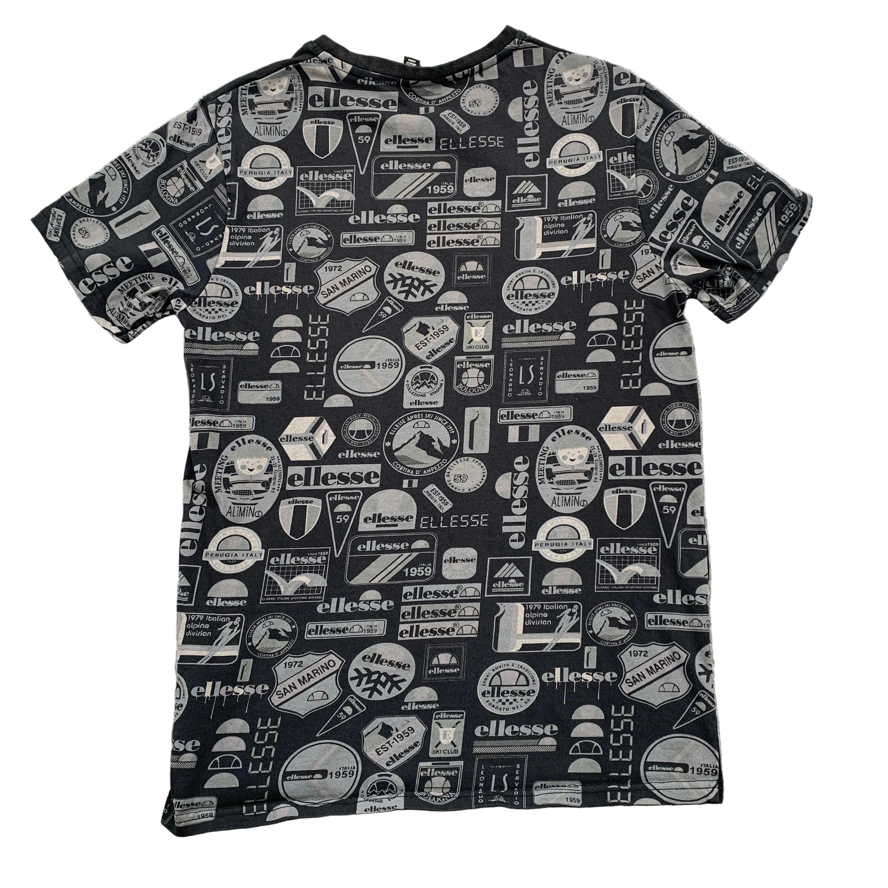 Black t-shirt with white logos and text on a gray surface