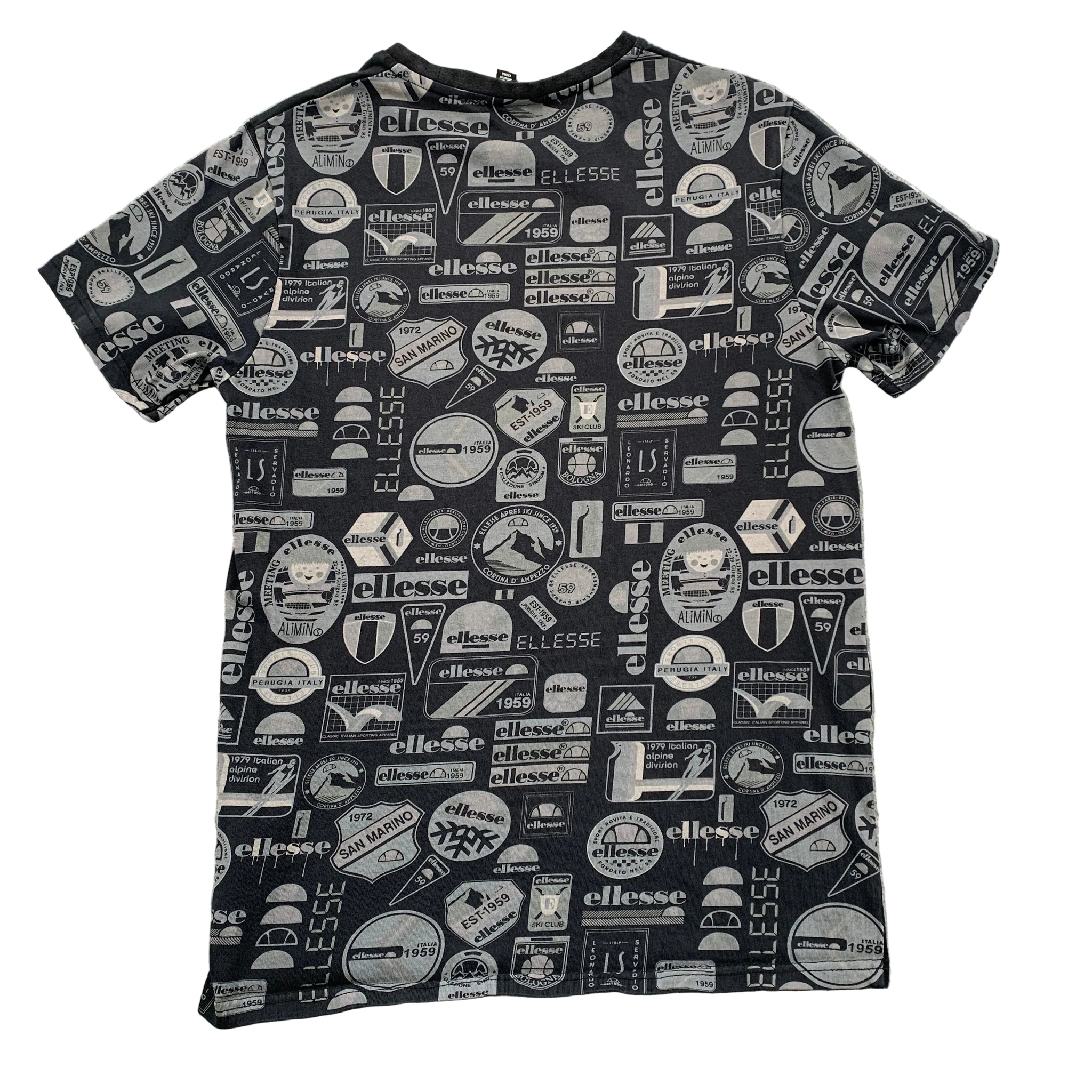 Black t-shirt with white logos and text on a gray surface