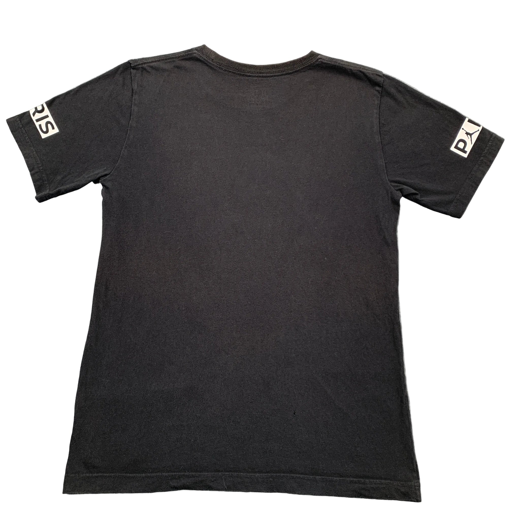 Black t-shirt with brand logos on sleeves against a gray background