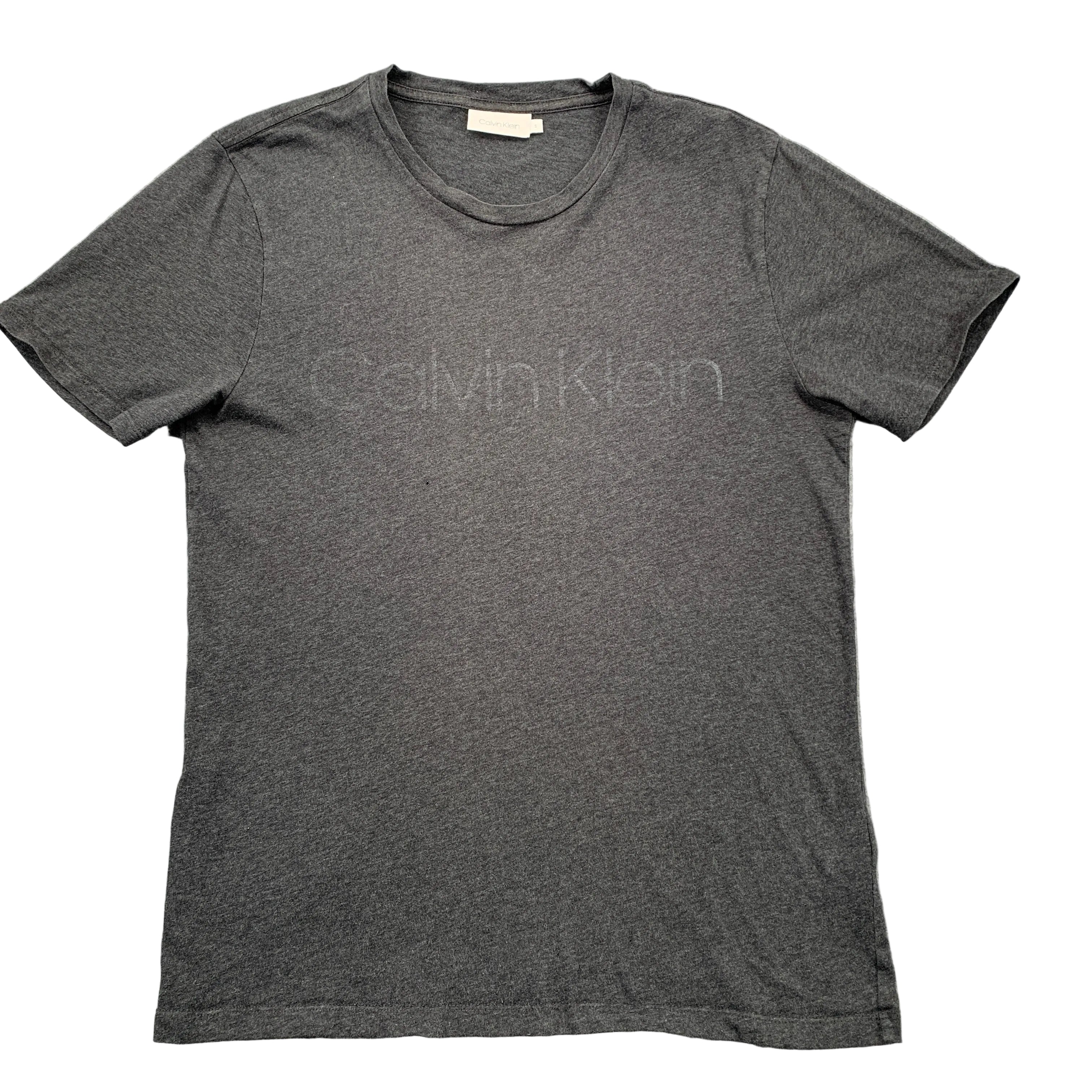 Gray Calvin Klein t-shirt on a textured gray surface