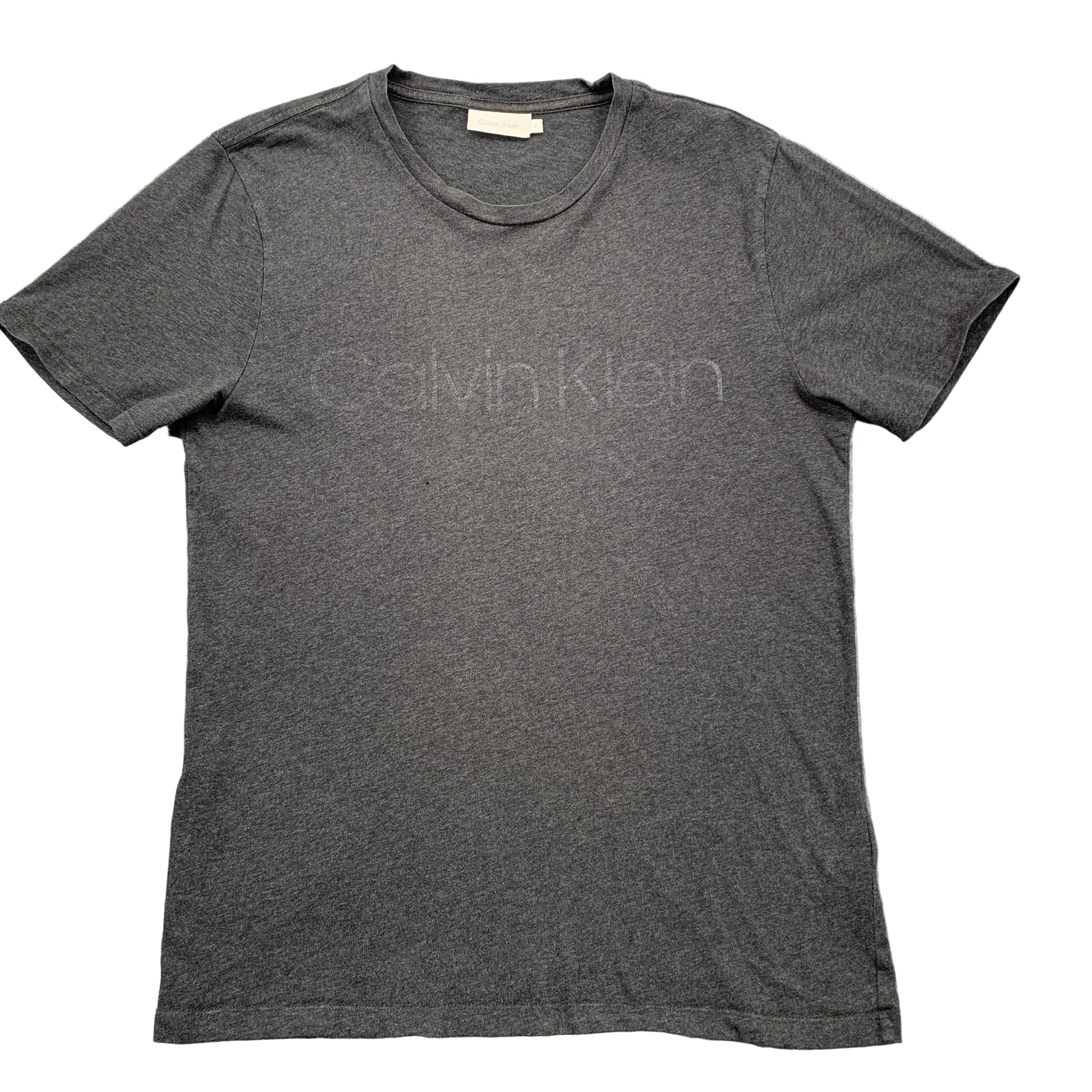 Gray Calvin Klein t-shirt on a textured gray surface