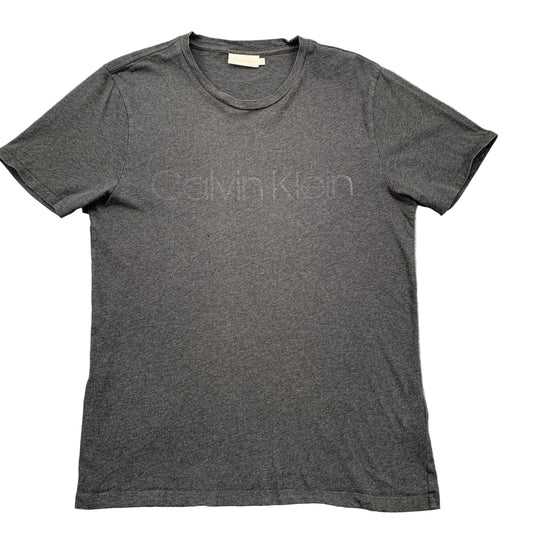 Gray Calvin Klein t-shirt on a textured gray surface