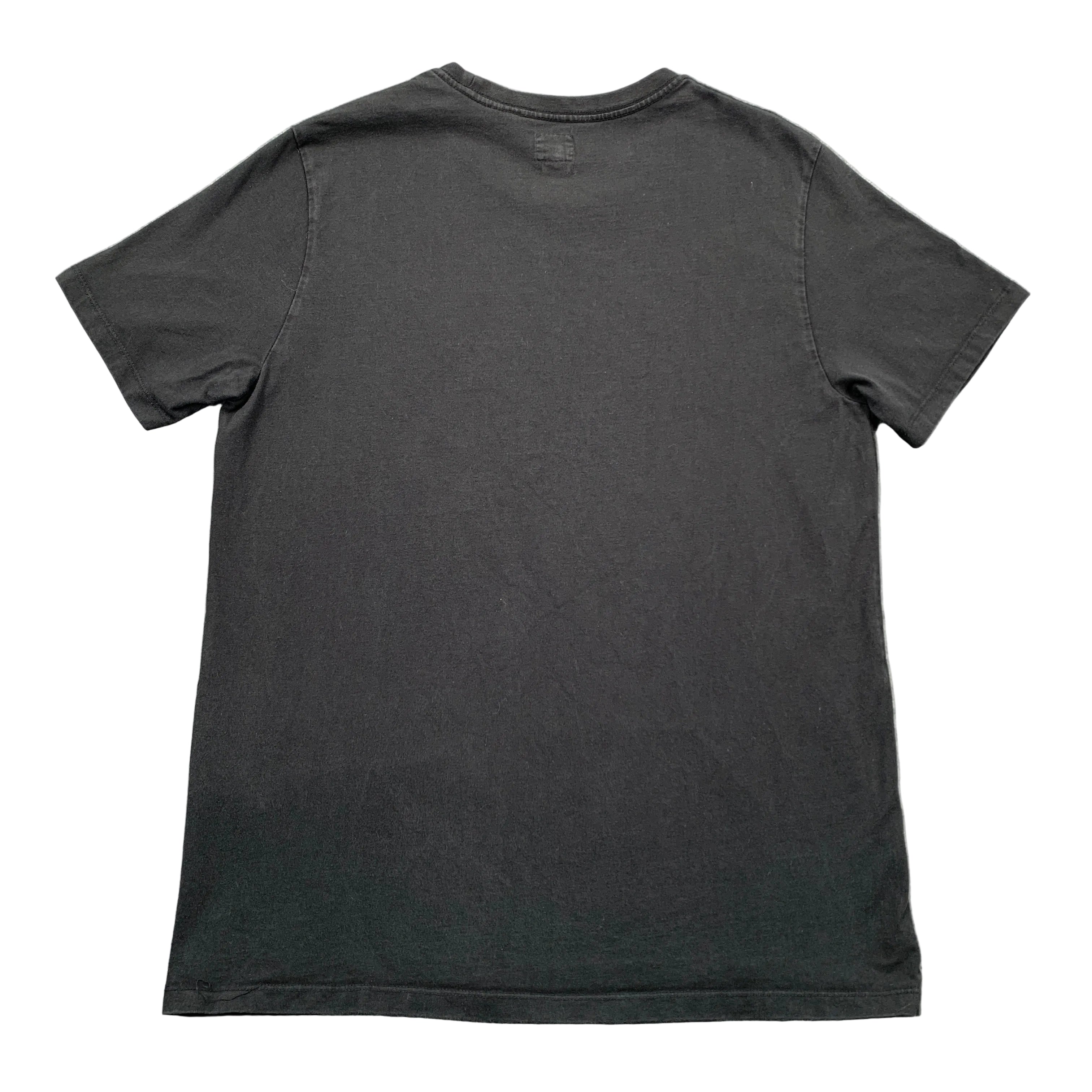 Black t-shirt on a textured gray surface