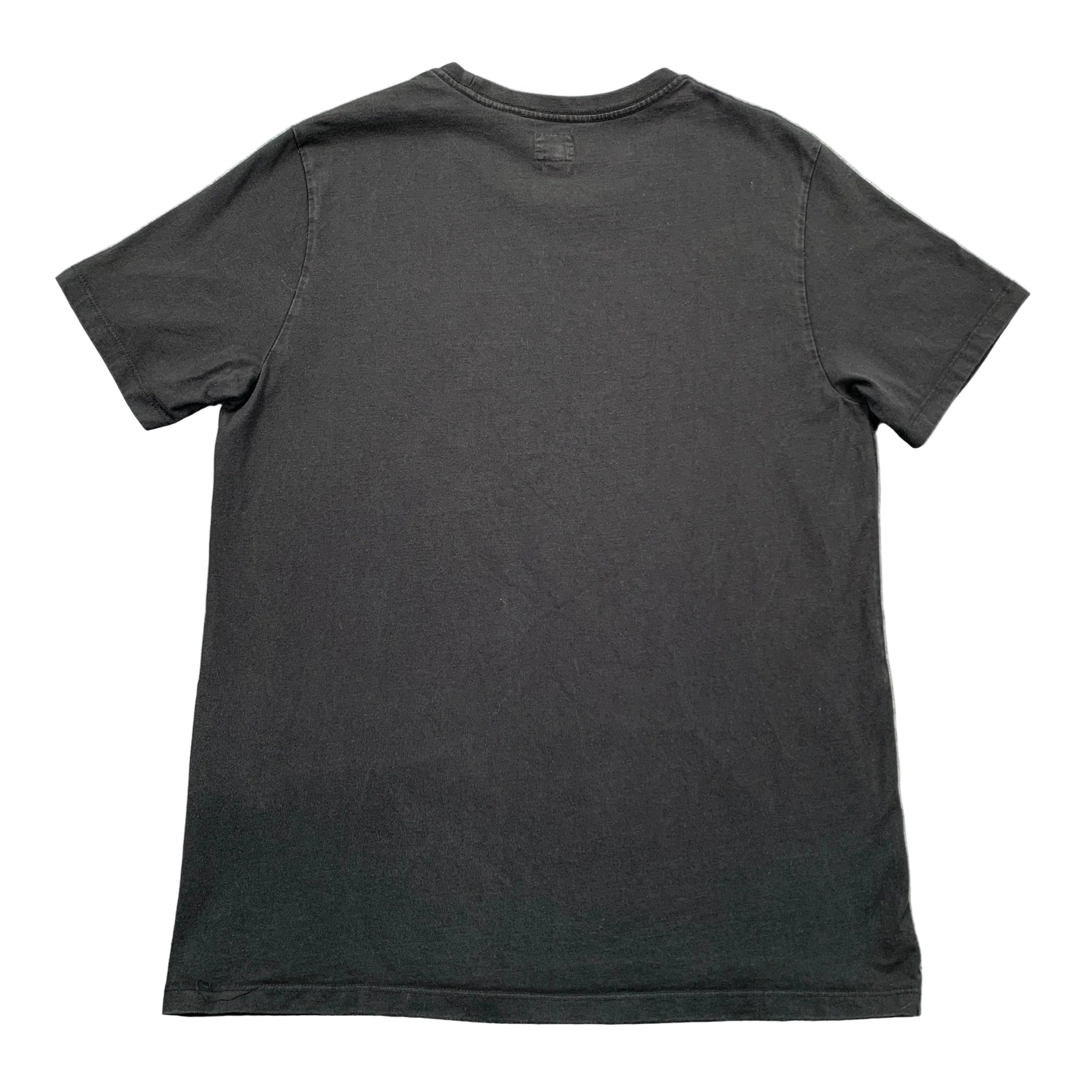 Black t-shirt on a textured gray surface