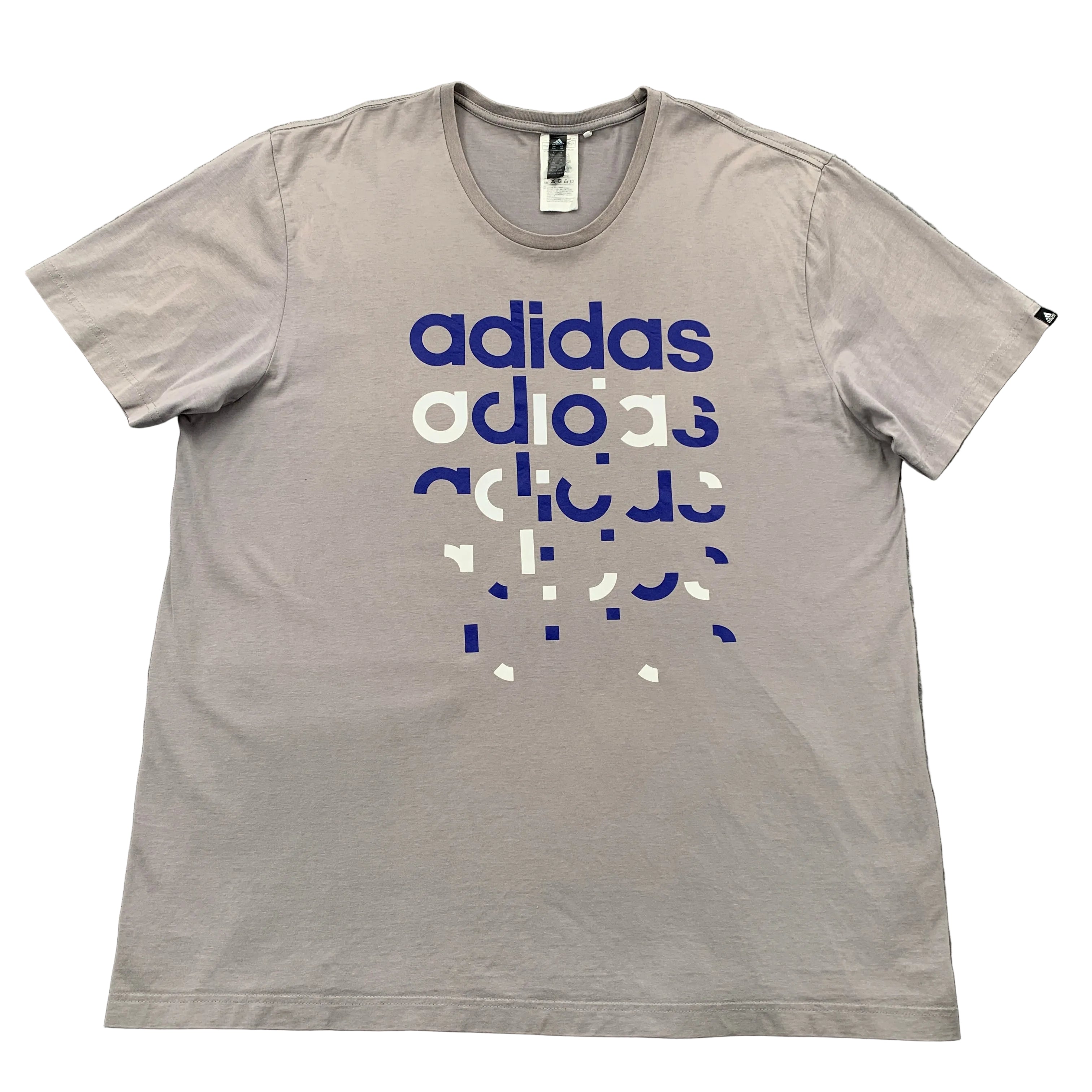 Gray t-shirt with Adidas logo and text on a gray surface