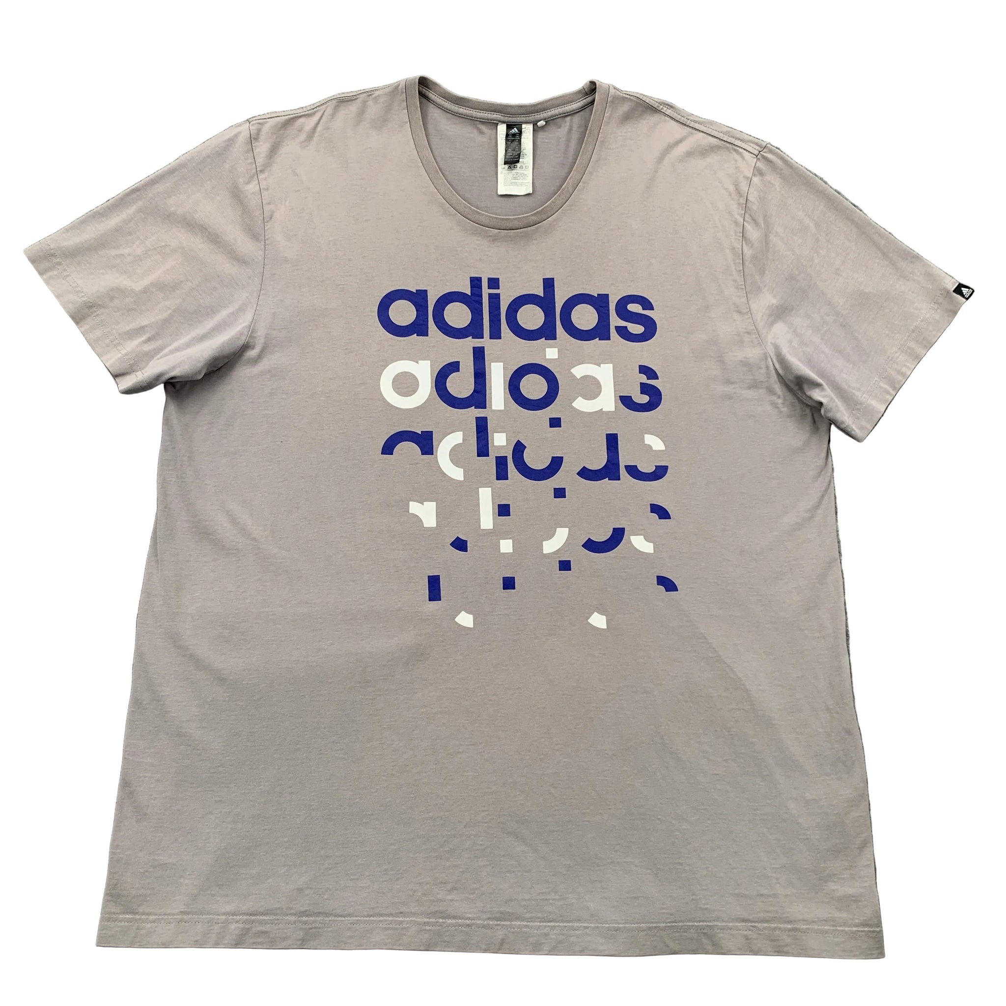 Gray t-shirt with Adidas logo and text on a gray surface