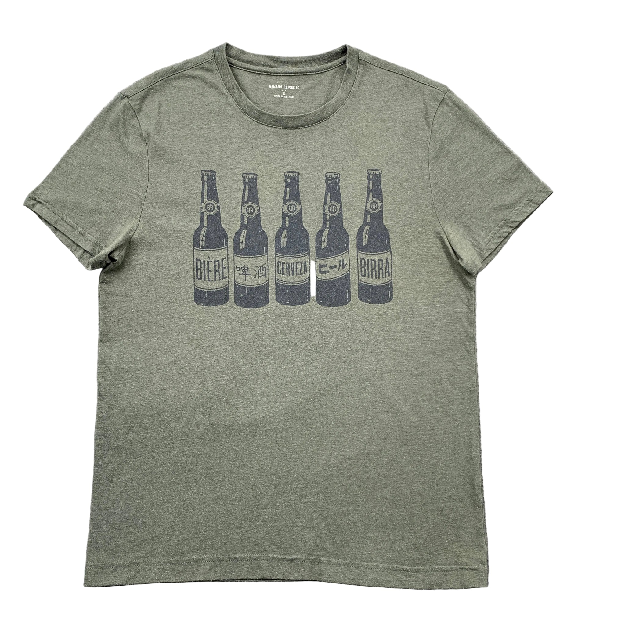 Green t-shirt with beer bottle graphic on a gray surface