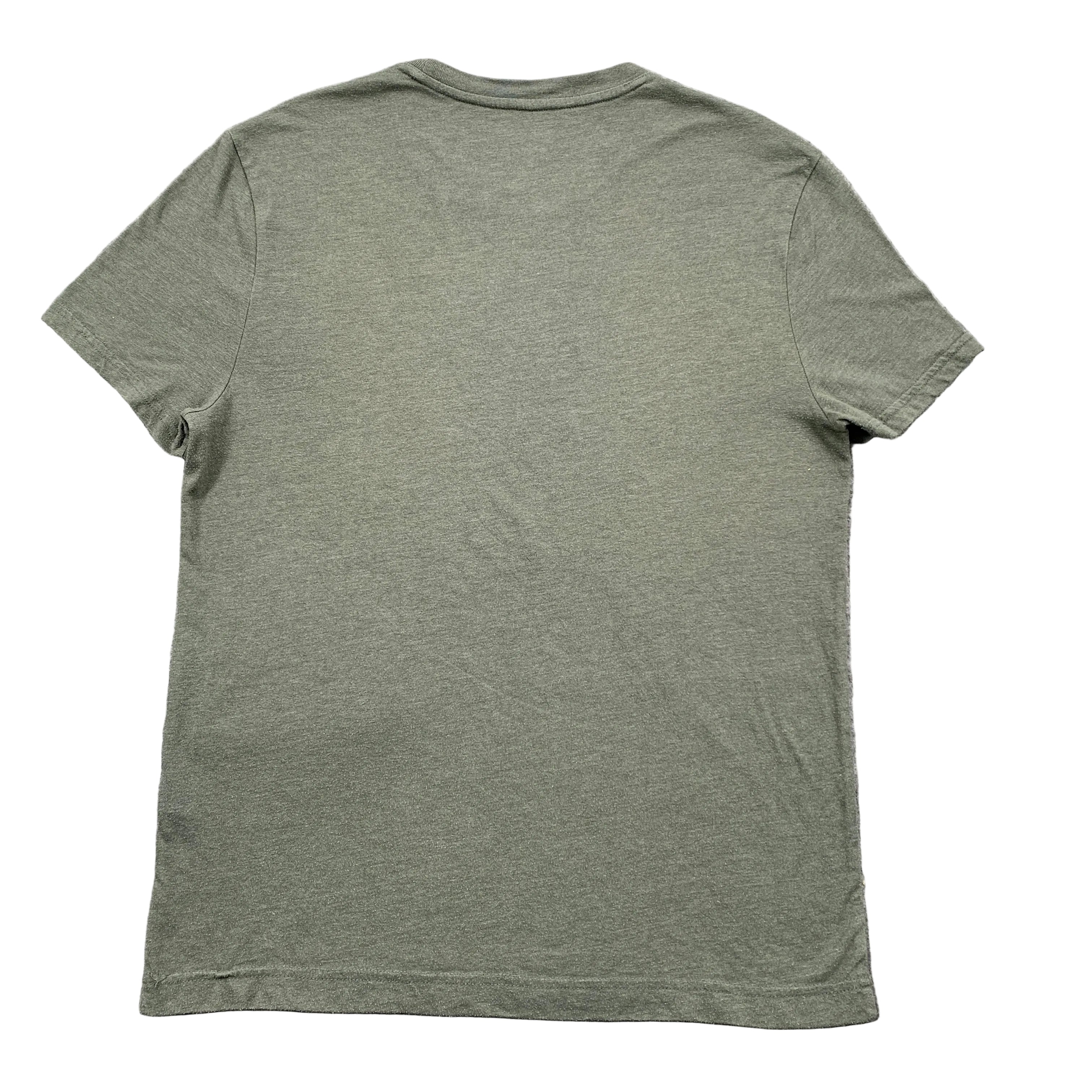 Green t-shirt on a textured gray surface