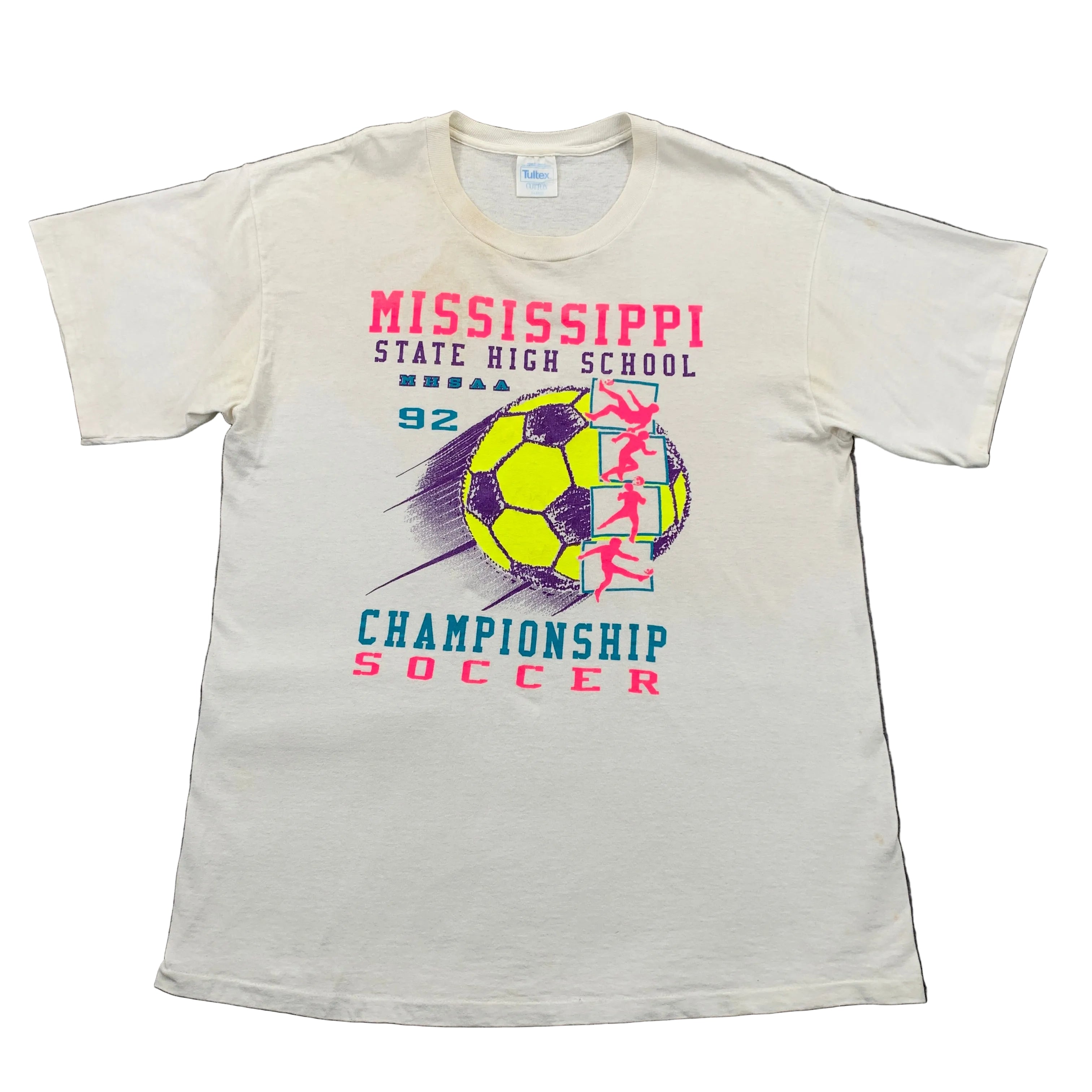 White t-shirt with Mississippi State High School championship soccer design on a gray surface