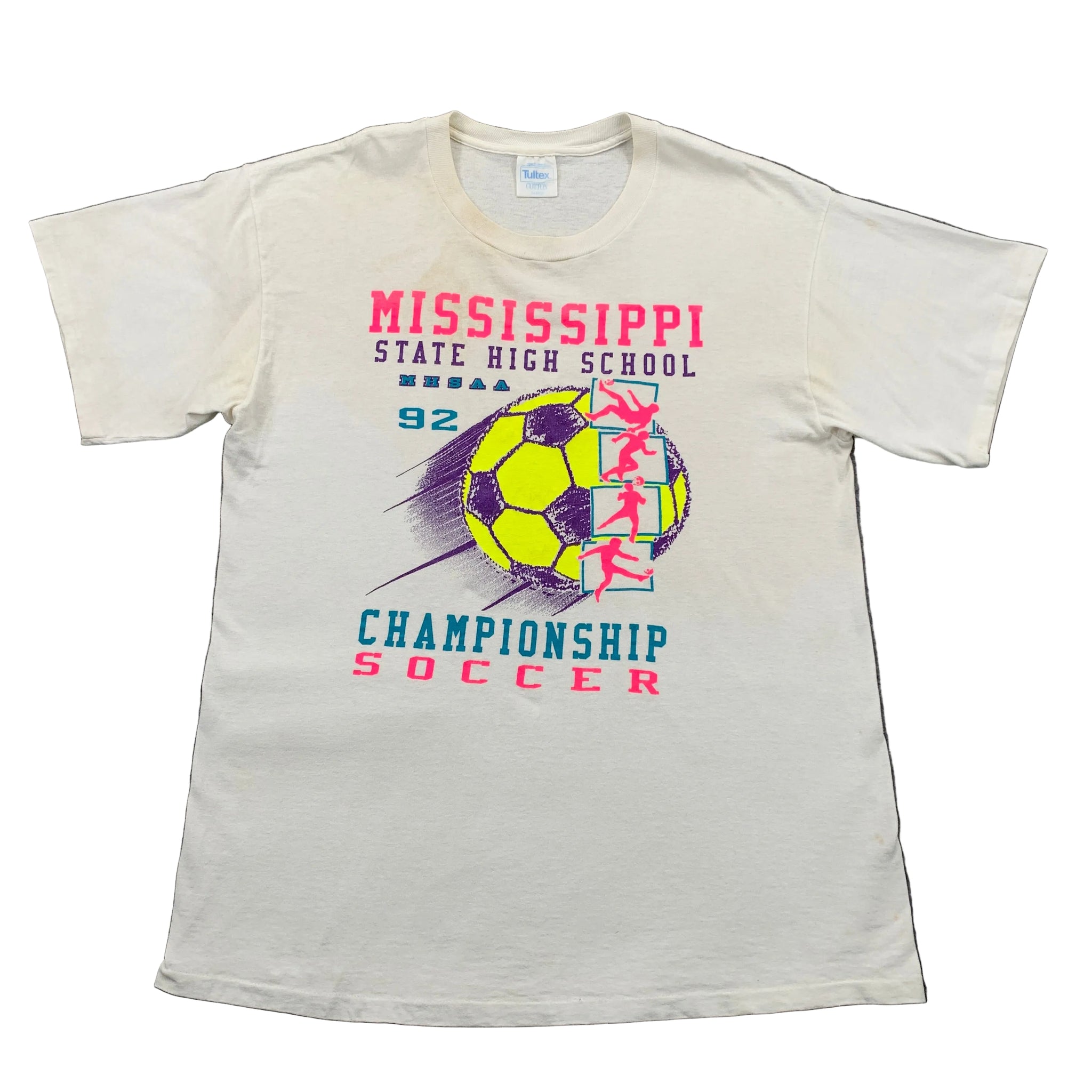 White t-shirt with Mississippi State High School championship soccer design on a gray surface