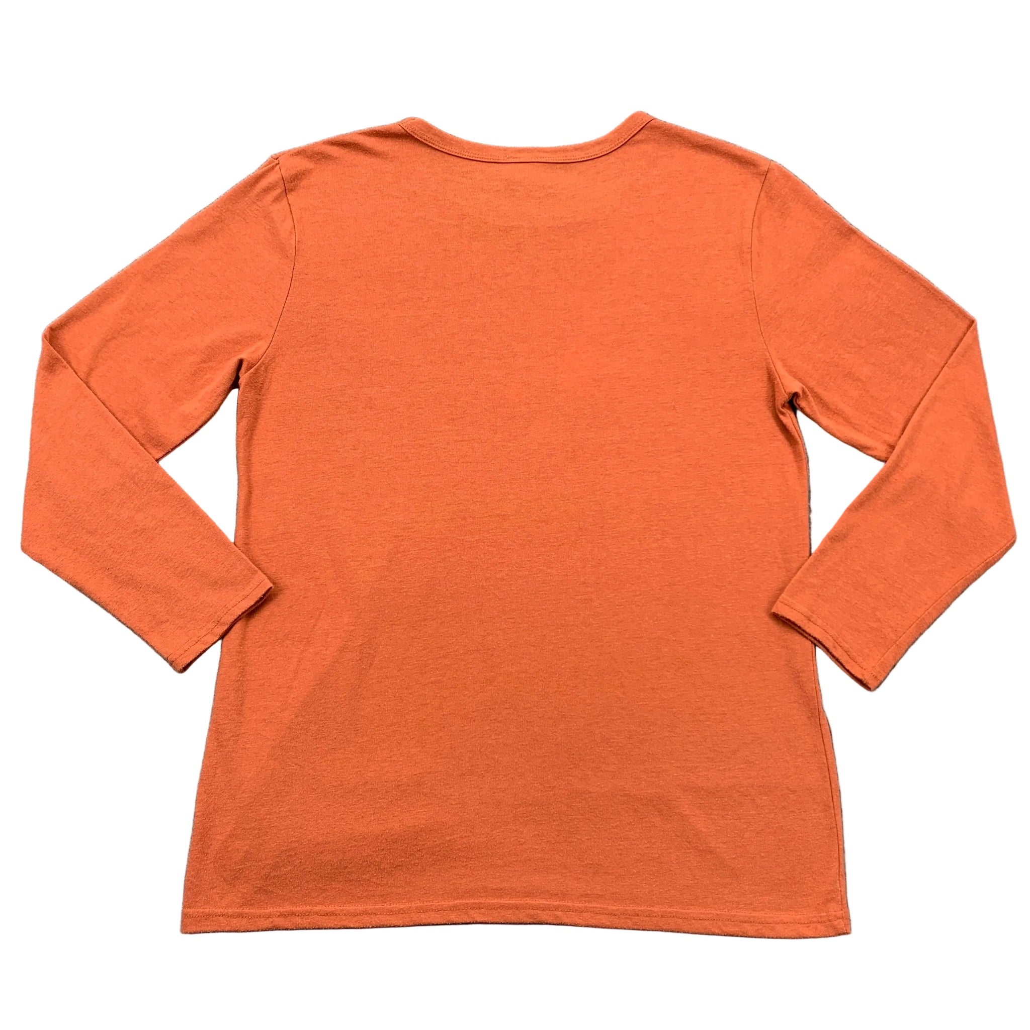 Orange long-sleeve shirt on a gray textured surface