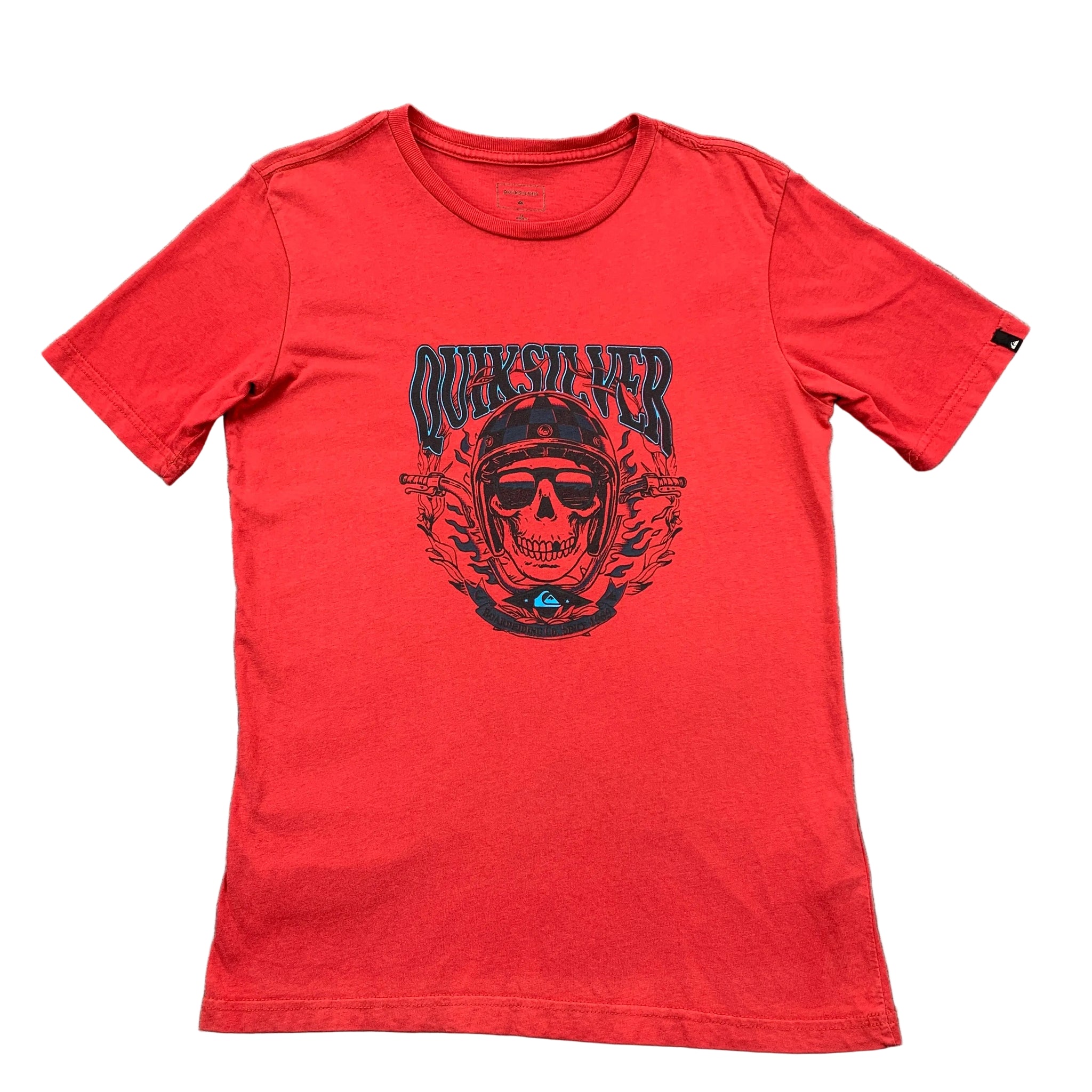 Red t-shirt with a skull and logo design on a gray surface