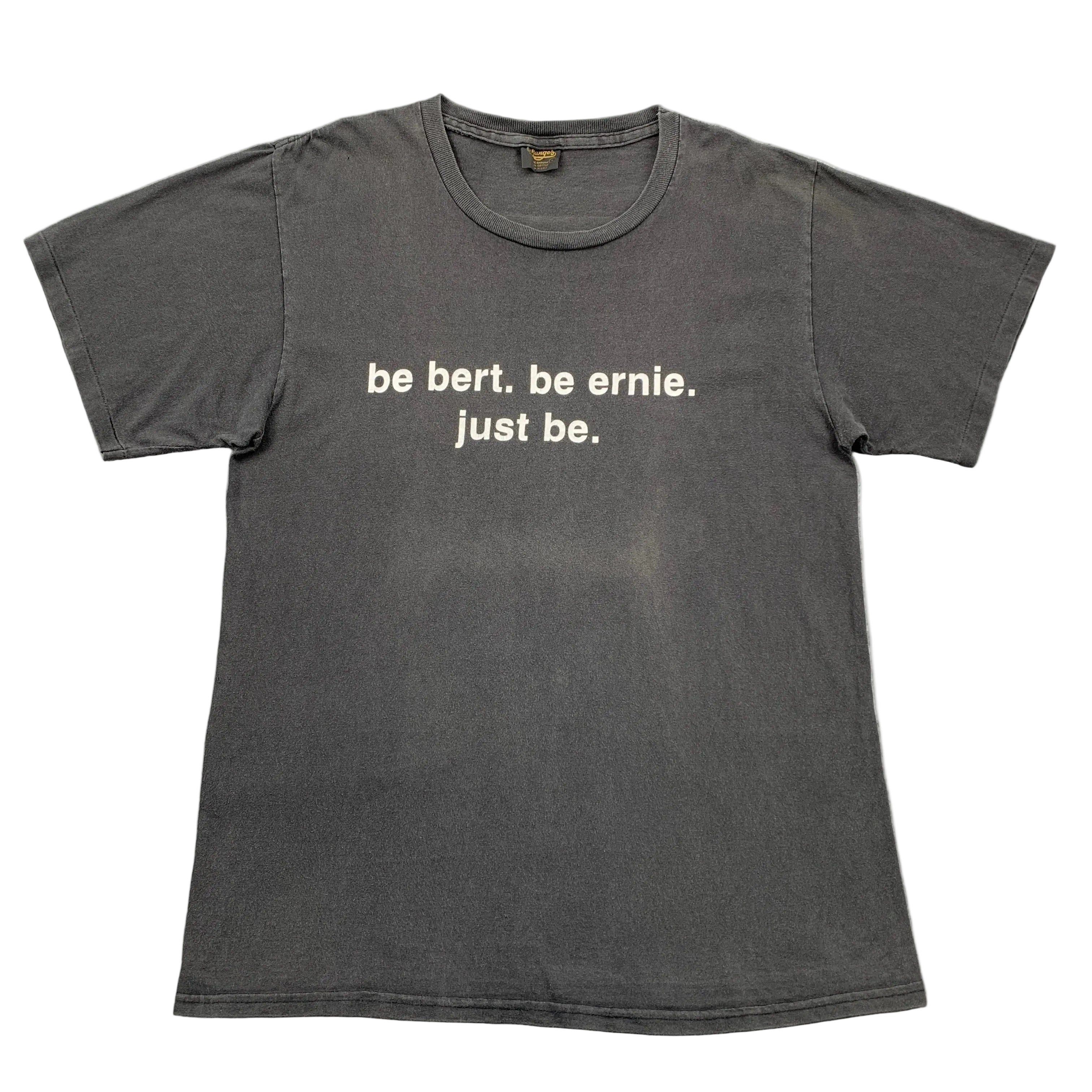 Gray t-shirt with white text on a gray surface