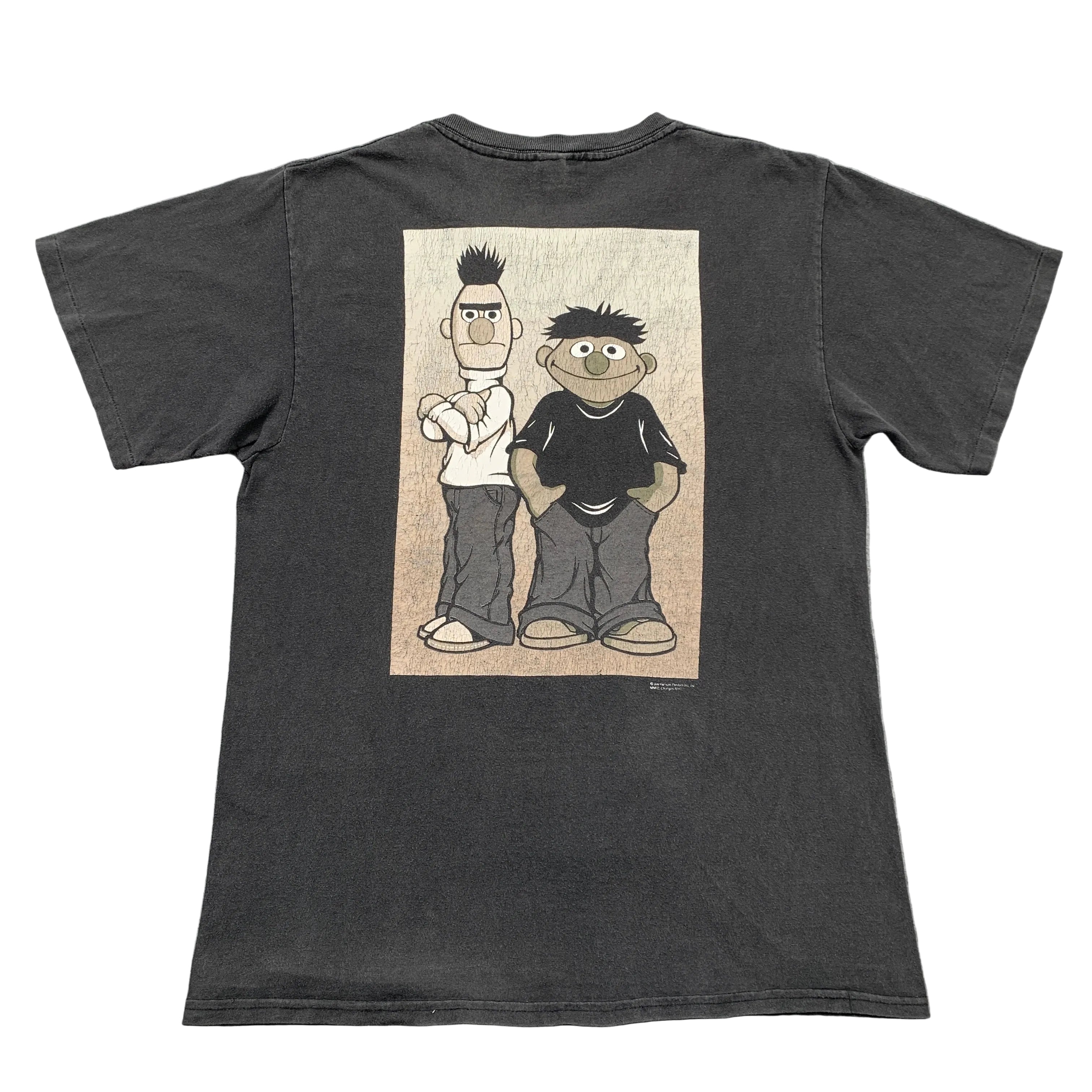 Black t-shirt with cartoon characters on a textured surface