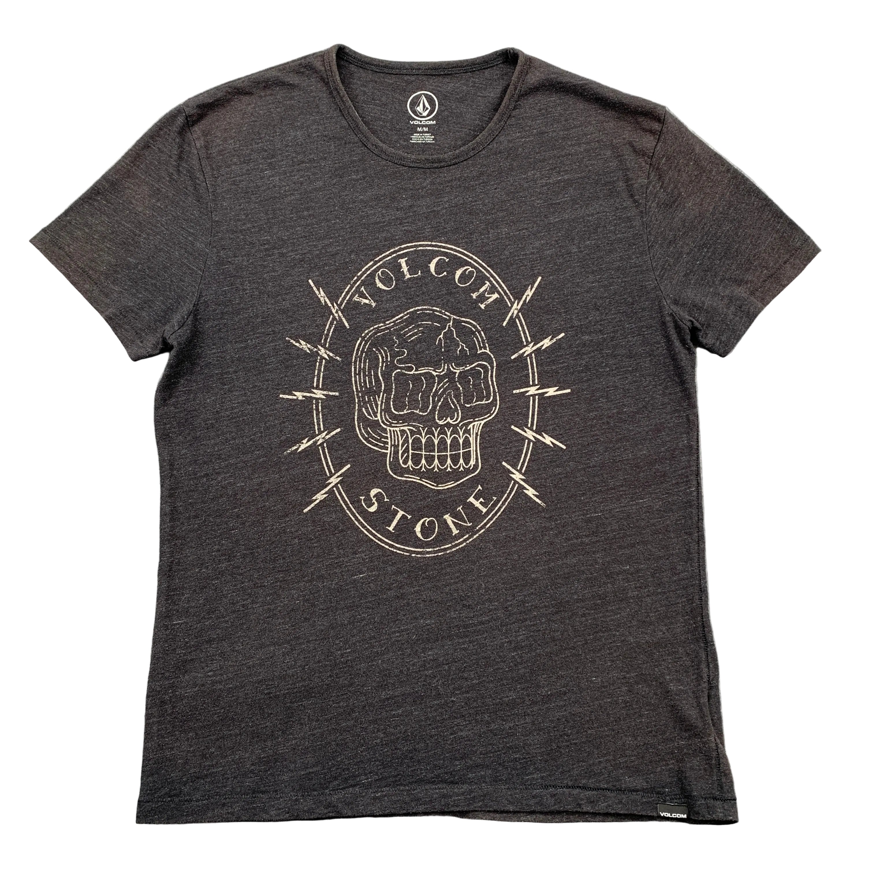 Black t-shirt with a skull design and 'Volcom' branding on a gray surface