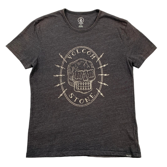 Black t-shirt with a skull design and 'Volcom' branding on a gray surface