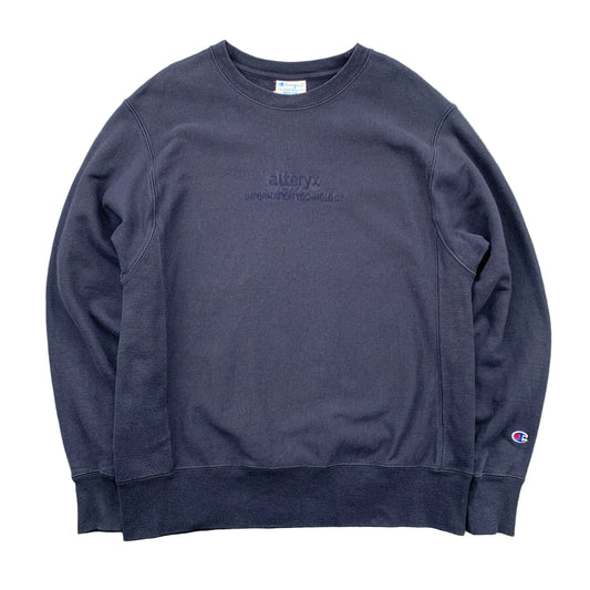 Navy blue sweatshirt with branding on a gray surface