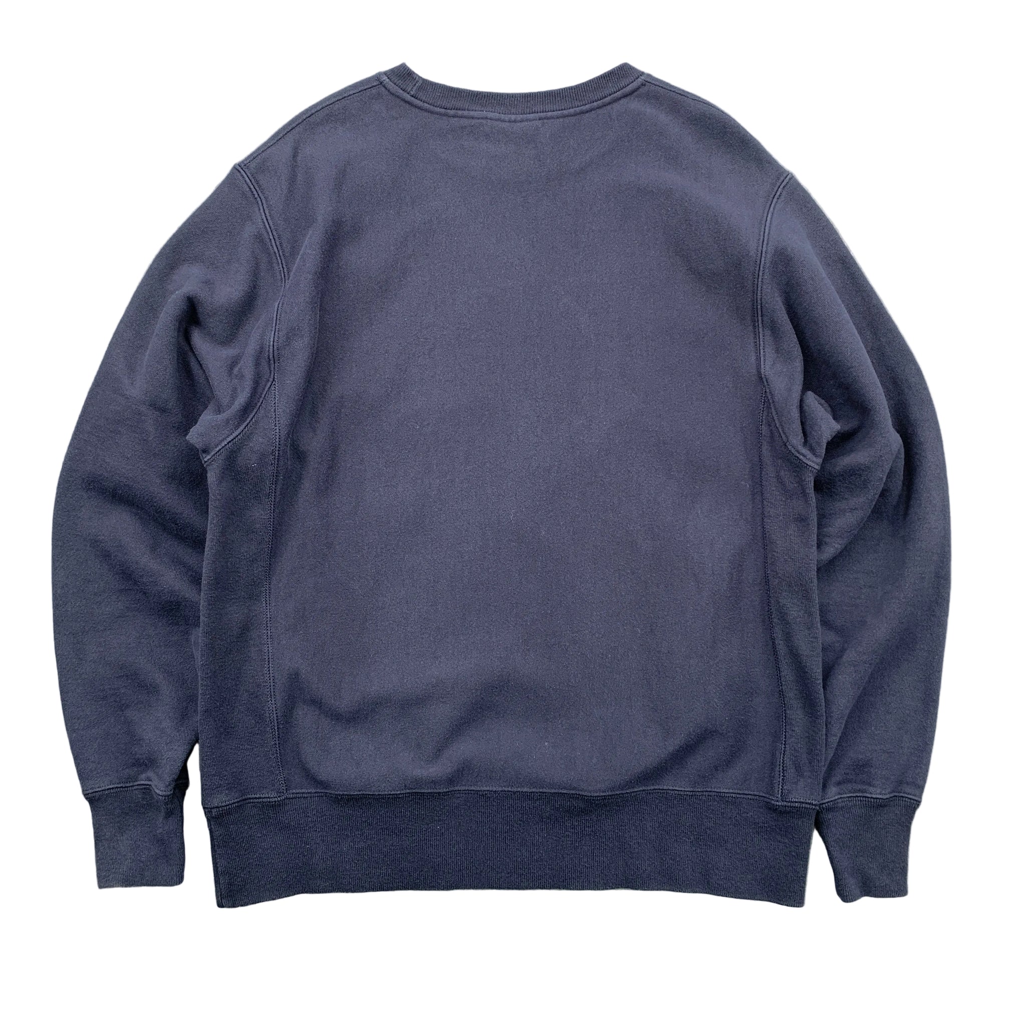 Navy blue sweatshirt on a gray textured background