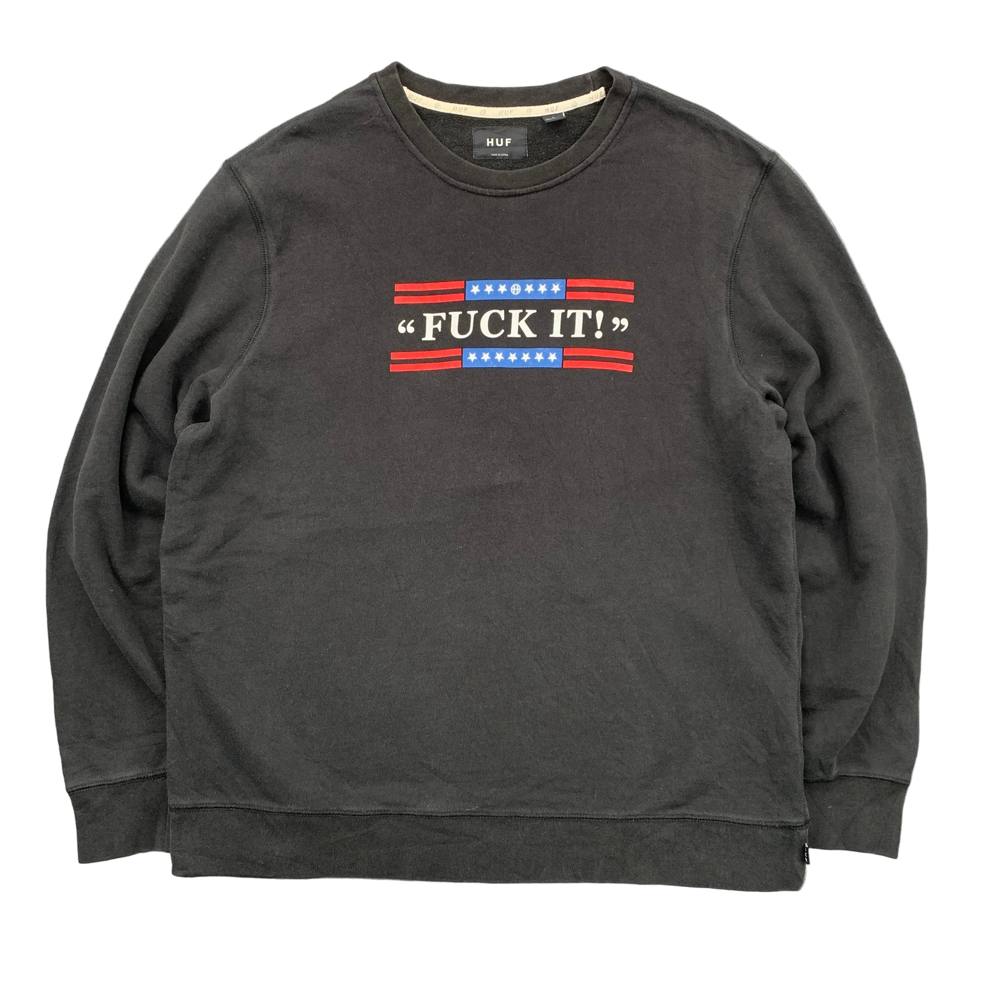Black sweatshirt with red, white, and blue graphic on a gray background